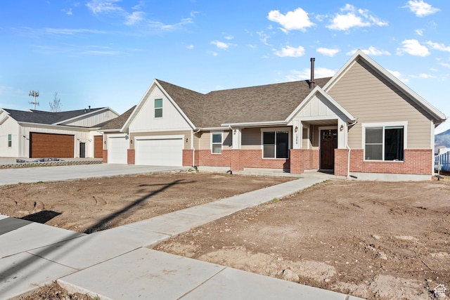 1984 S 4300 W, Ogden, UT 84401 - view of front of house featuring a shingled roof, concrete driveway, a garage, and brick siding