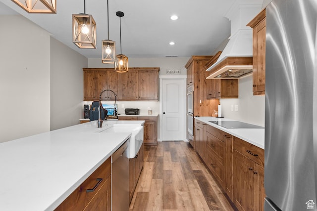 1984 S 4300 W, Ogden, UT 84401 - kitchen with stainless steel appliances, wood finished floors, brown cabinetry, and custom range hood