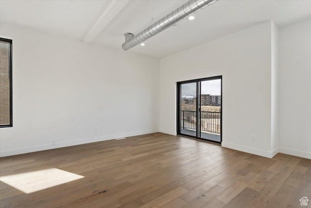 empty room with recessed lighting, baseboards, and wood finished floors