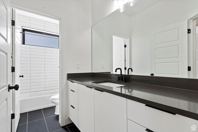 full bath with tile patterned floors, toilet, vanity, and shower / tub combination