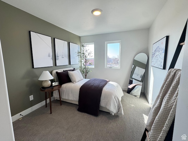 bedroom featuring carpet flooring and baseboards