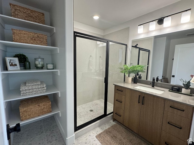 full bathroom featuring baseboards, a stall shower, and vanity