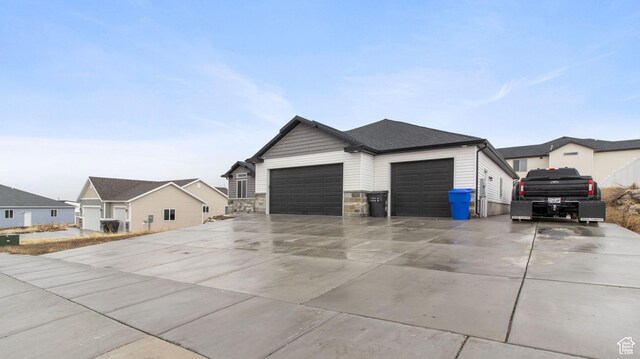 1081 N 2800 W, Tremonton, UT 84337 - view of property exterior with concrete driveway, an attached garage, stone siding, and a shingled roof