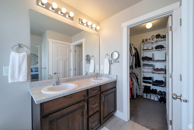 4726 W Plainfield Rd S, Herriman, UT 84096 - full bath with a sink, a walk in closet, baseboards, and double vanity