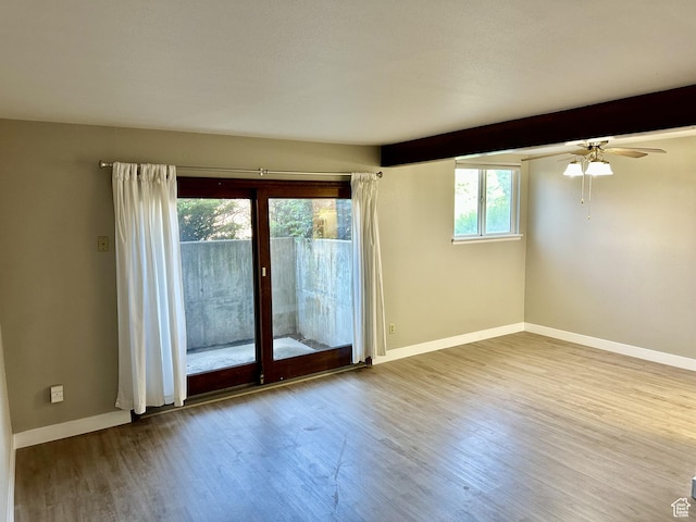 1170 S Foothill Dr Unit 311, Salt Lake City, UT 84108 - empty room featuring wood finished floors, ceiling fan, and beamed ceiling