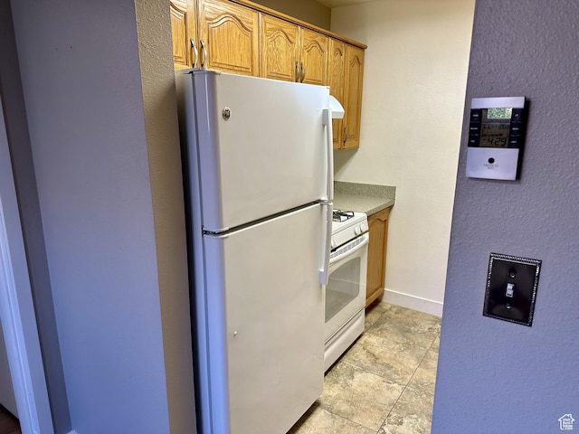 1170 S Foothill Dr Unit 311, Salt Lake City, UT 84108 - kitchen with white appliances and baseboards