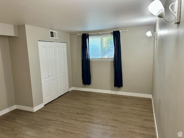 1170 S Foothill Dr Unit 311, Salt Lake City, UT 84108 - unfurnished bedroom with wood finished floors and a closet