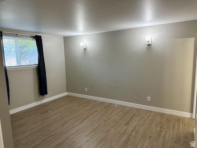 1170 S Foothill Dr Unit 311, Salt Lake City, UT 84108 - spare room featuring wood finished floors and baseboards