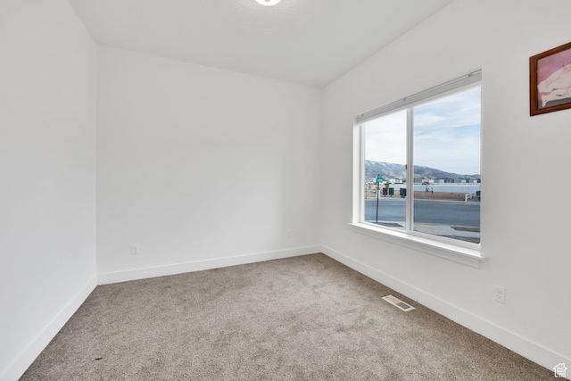 1373 E Bell Buoy Way S, Eagle Mountain, UT 84005 - spare room featuring visible vents, carpet flooring, a mountain view, and baseboards