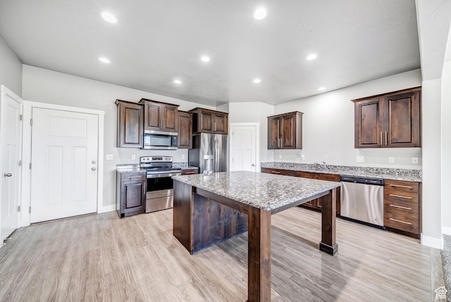 8052 N Rock Creek Cove Ln, Eagle Mountain, UT 84005 - kitchen featuring dark brown cabinets, appliances with stainless steel finishes, light wood-style flooring, and recessed lighting