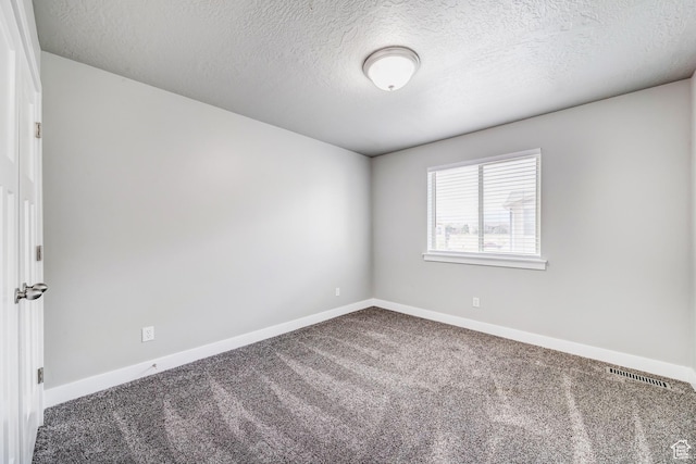 8052 N Rock Creek Cove Ln, Eagle Mountain, UT 84005 - carpeted spare room with baseboards, visible vents, and a textured ceiling