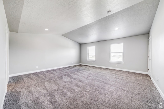 8052 N Rock Creek Cove Ln, Eagle Mountain, UT 84005 - empty room featuring baseboards, lofted ceiling, carpet, and a textured ceiling