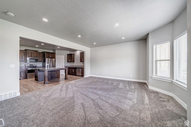 8052 N Rock Creek Cove Ln, Eagle Mountain, UT 84005 - living area featuring recessed lighting, light colored carpet, and baseboards