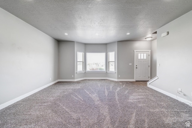 8052 N Rock Creek Cove Ln, Eagle Mountain, UT 84005 - unfurnished living room featuring recessed lighting, baseboards, carpet floors, and a textured ceiling