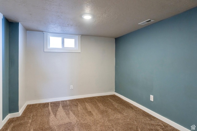 252 E 31st S, Ogden, UT 84401 - below grade area featuring a textured ceiling, carpet, visible vents, and baseboards