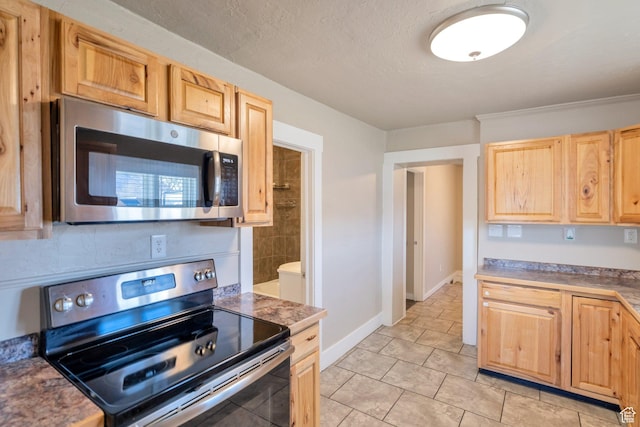 252 E 31st S, Ogden, UT 84401 - kitchen featuring baseboards, a textured ceiling, appliances with stainless steel finishes, and light brown cabinetry