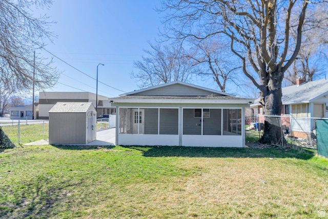 252 E 31st S, Ogden, UT 84401 - rear view of house featuring an outbuilding, a lawn, a fenced backyard, a storage shed, and a sunroom