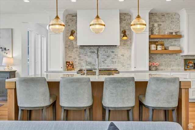 4875 N Vialetto Way, Lehi, UT 84043 - kitchen featuring tasteful backsplash, a center island with sink, white cabinetry, and light countertops
