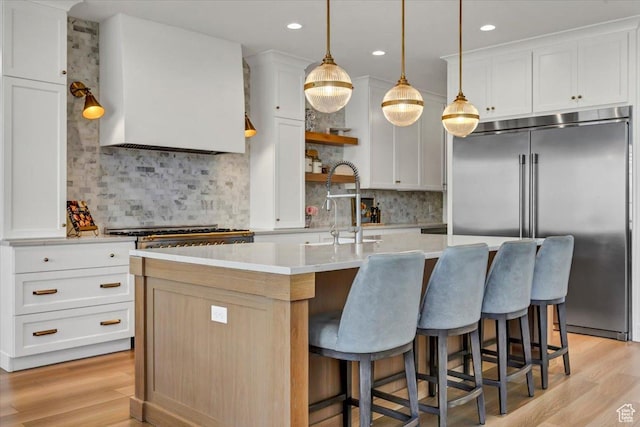 4875 N Vialetto Way, Lehi, UT 84043 - kitchen with light wood finished floors, a center island with sink, built in refrigerator, and light countertops