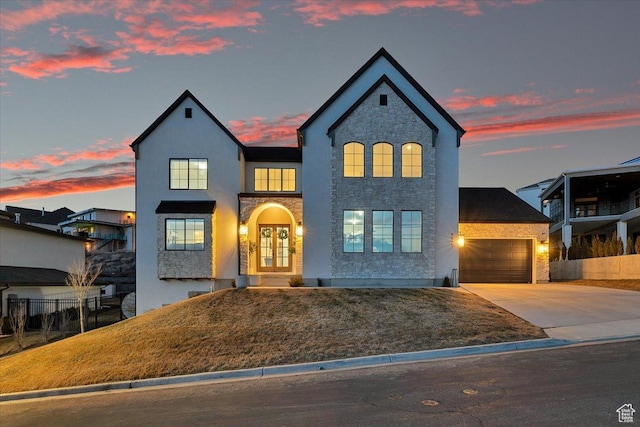 4875 N Vialetto Way, Lehi, UT 84043 - view of front facade with stucco siding, fence, french doors, concrete driveway, and a garage
