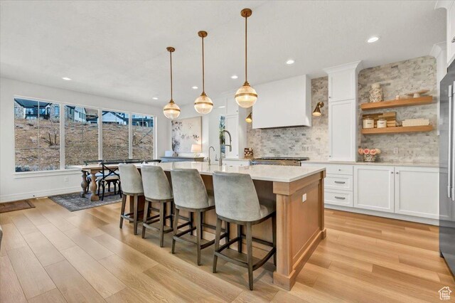 4875 N Vialetto Way, Lehi, UT 84043 - kitchen featuring light countertops, white cabinets, light wood-style floors, and backsplash