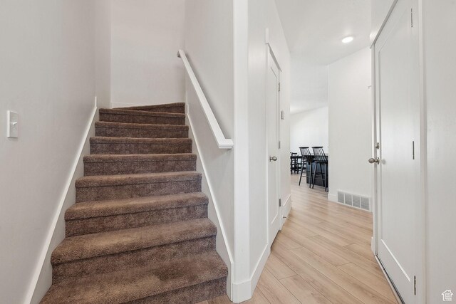 4905 E Lake Corner Dr, Eagle Mountain, UT 84005 - stairs with wood finished floors, visible vents, and baseboards