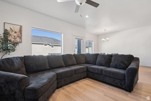 4905 E Lake Corner Dr, Eagle Mountain, UT 84005 - living room with light wood-style flooring and ceiling fan with notable chandelier