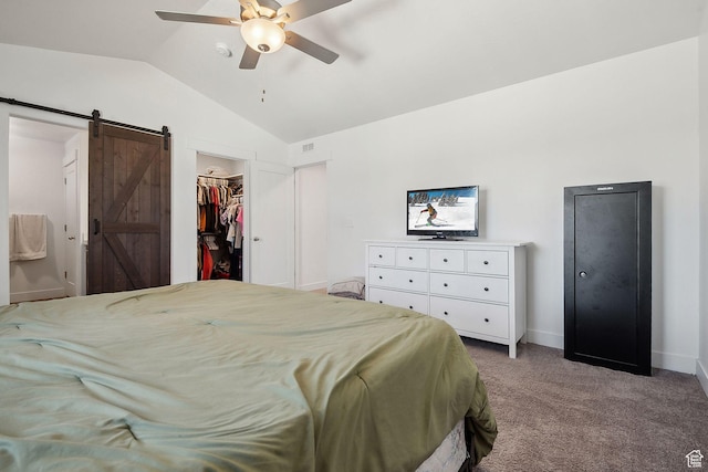 4905 E Lake Corner Dr, Eagle Mountain, UT 84005 - carpeted bedroom featuring visible vents, lofted ceiling, ceiling fan, a walk in closet, and a barn door