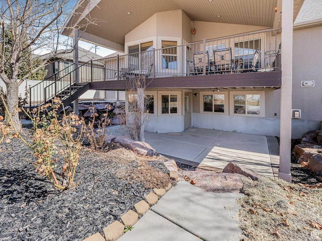 3265 N 1050 W, Pleasant View, UT 84414 - rear view of house featuring stairs, a patio, and stucco siding