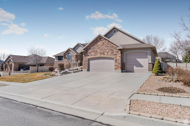 3265 N 1050 W, Pleasant View, UT 84414 - view of front of home with a garage, stone siding, driveway, and fence