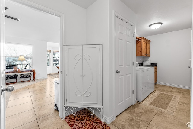 3265 N 1050 W, Pleasant View, UT 84414 - washroom with light tile patterned floors, cabinet space, baseboards, and washing machine and clothes dryer