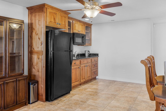 3265 N 1050 W, Pleasant View, UT 84414 - kitchen featuring brown cabinets, black appliances, a sink, dark stone counters, and glass insert cabinets