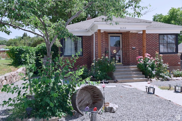 1653 E Lake St, Ogden, UT 84401 - view of front facade featuring brick siding and a shingled roof