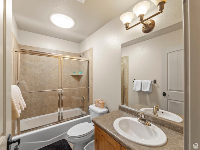 2 Desert Wind Dr Unit 2, Moab, UT 84532 - bathroom with a notable chandelier, shower / bath combination with glass door, vanity, and toilet