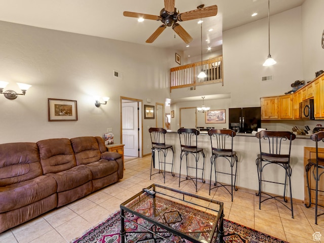 2 Desert Wind Dr Unit 2, Moab, UT 84532 - living room featuring light tile patterned flooring, visible vents, and ceiling fan with notable chandelier