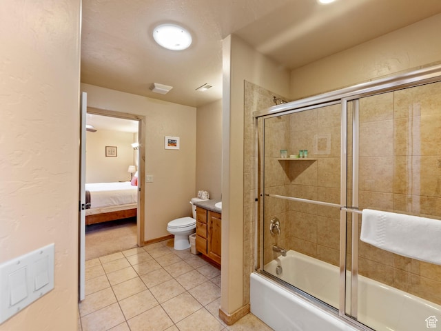 2 Desert Wind Dr Unit 2, Moab, UT 84532 - ensuite bathroom with connected bathroom, bath / shower combo with glass door, toilet, tile patterned floors, and vanity