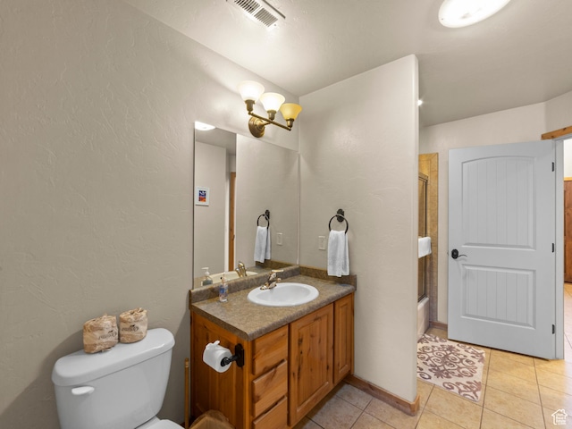 2 Desert Wind Dr Unit 2, Moab, UT 84532 - full bath with visible vents, toilet, combined bath / shower with glass door, tile patterned flooring, and vanity