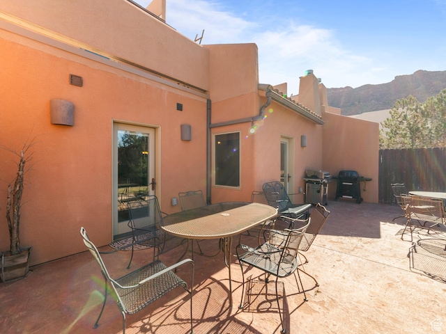 2 Desert Wind Dr Unit 2, Moab, UT 84532 - view of patio / terrace featuring a mountain view, grilling area, outdoor dining space, and fence