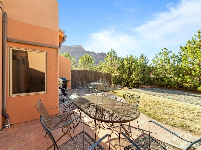 2 Desert Wind Dr Unit 2, Moab, UT 84532 - view of patio featuring outdoor dining space, fence, and a mountain view