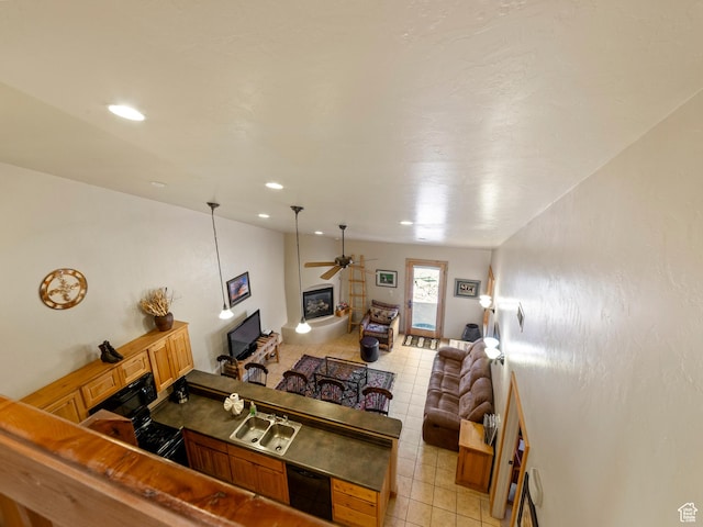 2 Desert Wind Dr Unit 2, Moab, UT 84532 - living room featuring a glass covered fireplace, vaulted ceiling, light tile patterned flooring, and a ceiling fan
