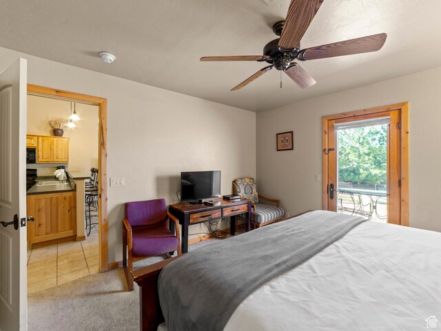 2 Desert Wind Dr Unit 2, Moab, UT 84532 - bedroom featuring light carpet, a ceiling fan, a sink, light tile patterned flooring, and access to exterior