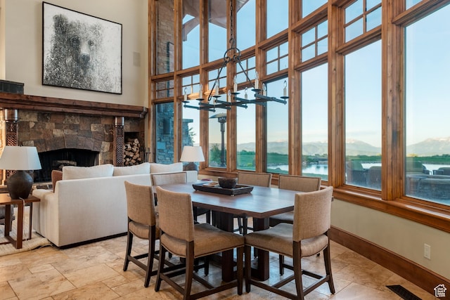 8376 E Aspen Rdg Unit 44, Heber City, UT 84032 - dining space with a stone fireplace, a water view, and light stone finish flooring