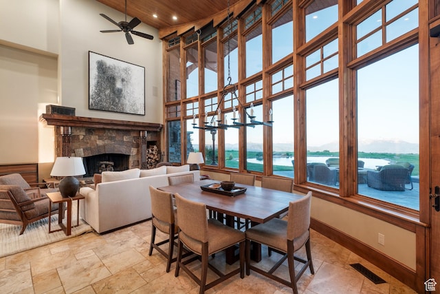 8376 E Aspen Rdg Unit 44, Heber City, UT 84032 - dining area with a fireplace, a towering ceiling, a ceiling fan, recessed lighting, and light stone finish floors