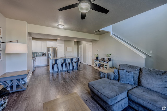 1997 E Abbey Way S, Eagle Mountain, UT 84005 - living room with dark wood-style floors, visible vents, a textured ceiling, and ceiling fan