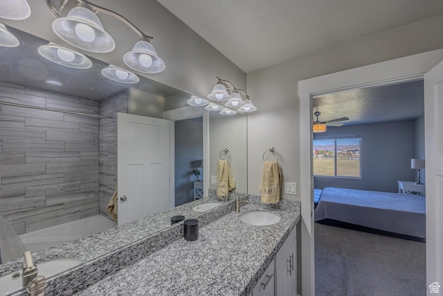 1997 E Abbey Way S, Eagle Mountain, UT 84005 - ensuite bathroom featuring vanity, connected bathroom, tub / shower combination, and a textured ceiling