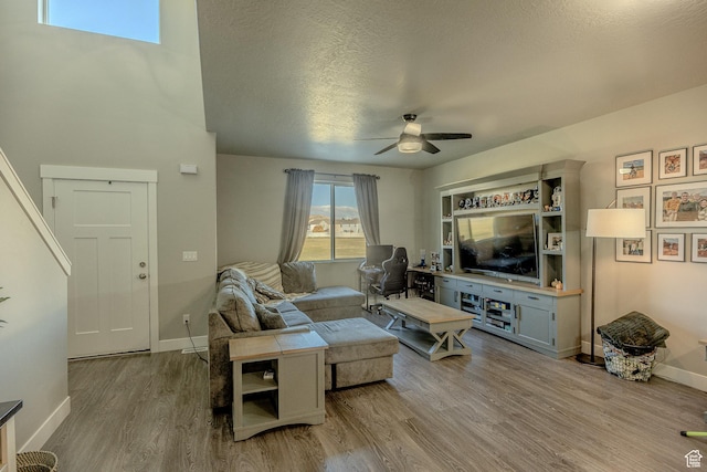 1997 E Abbey Way S, Eagle Mountain, UT 84005 - living room featuring ceiling fan, baseboards, a textured ceiling, and wood finished floors