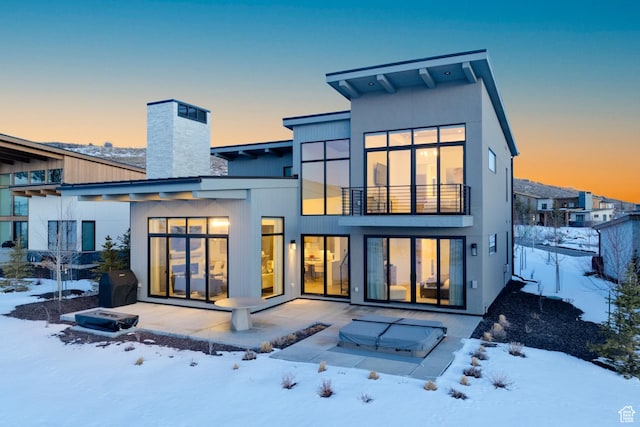5790 Cobalt Cir, Park City, UT 84098 - snow covered back of property with a balcony, a chimney, and a patio area