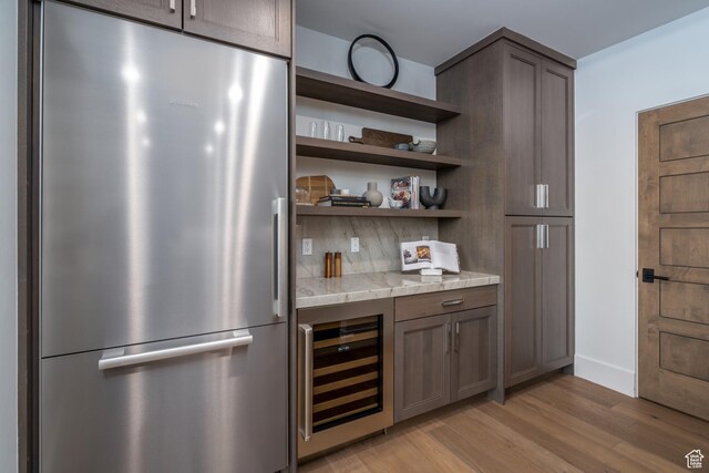 5790 Cobalt Cir, Park City, UT 84098 - bar featuring wine cooler, stainless steel fridge, light wood-style flooring, and baseboards
