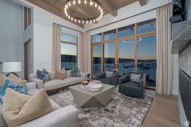 5790 Cobalt Cir, Park City, UT 84098 - living room featuring beamed ceiling, wood ceiling, wood finished floors, and a towering ceiling
