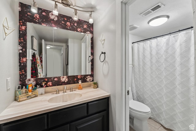 full bathroom with vanity, tile patterned floors, toilet, and visible vents